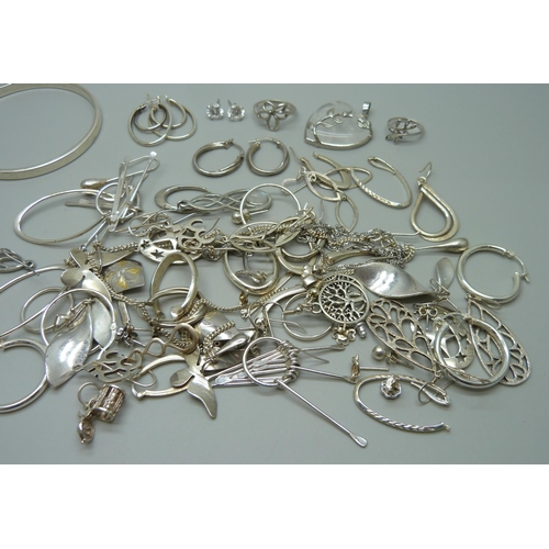 1058 - A collection of silver, white metal and plated jewellery, mostly earrings, together with a silver ba... 