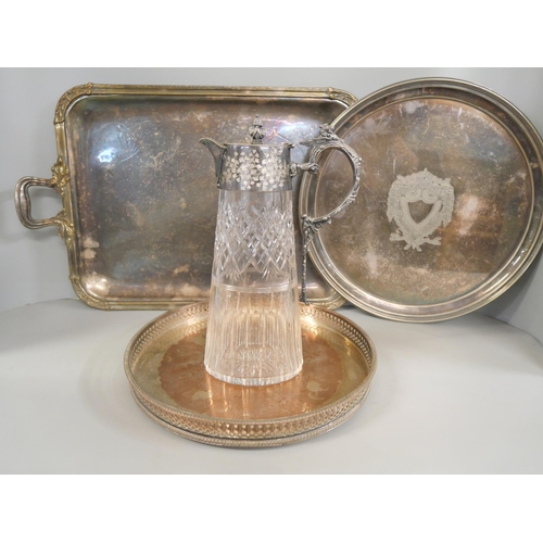 1065 - A silver plated gallery tray, two other plated trays and a plated claret  jug **PLEASE NOTE THIS LOT... 