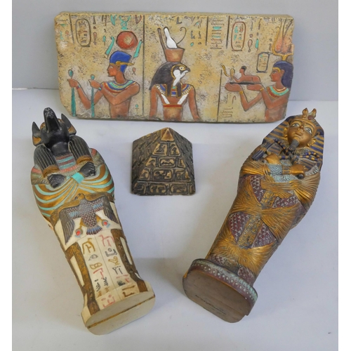 621 - A collection of Egyptian style souvenir pottery, a pyramid, wall plaque and two Mummies in tombs