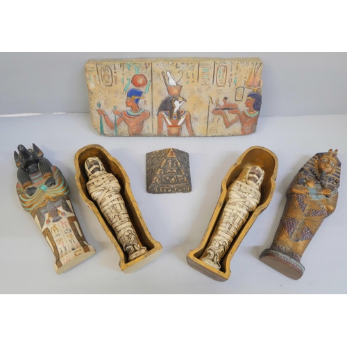 621 - A collection of Egyptian style souvenir pottery, a pyramid, wall plaque and two Mummies in tombs