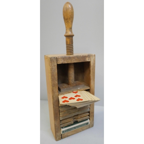 624 - A collection of 19th Century and early 20th Century playing cards in a wooden playing card press