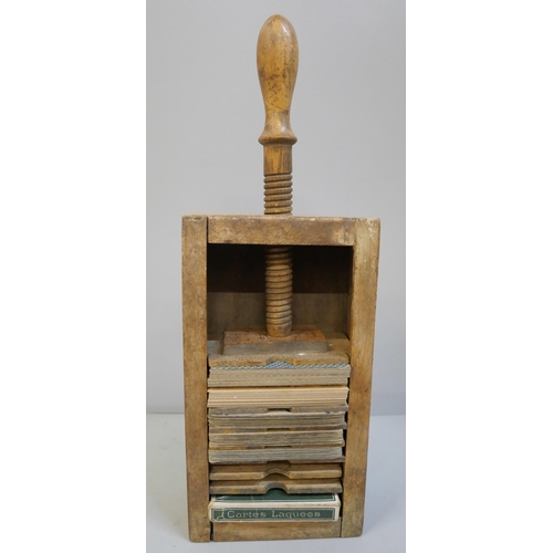 624 - A collection of 19th Century and early 20th Century playing cards in a wooden playing card press