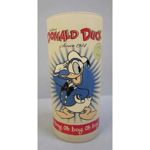 629 - A rare 1950s glass Donald Duck tumbler, a Washington Pottery Joe 90 cup and a pair of novelty Sooty ... 