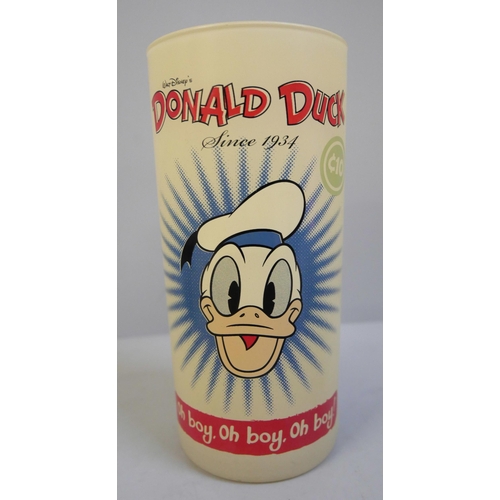 629 - A rare 1950s glass Donald Duck tumbler, a Washington Pottery Joe 90 cup and a pair of novelty Sooty ... 