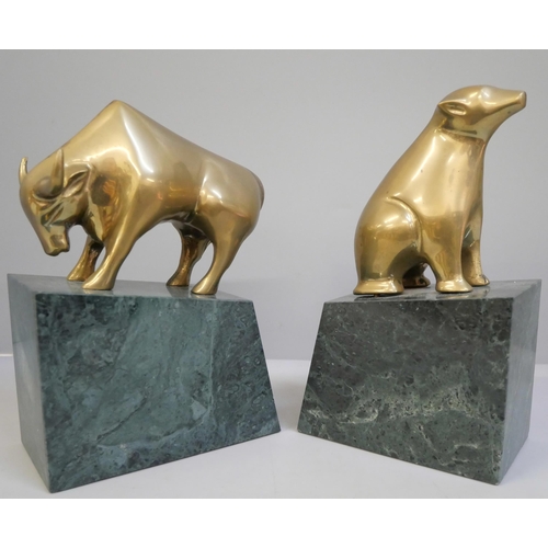 635 - A pair of brass Bull and Bear Wall Street bookends on green marble plinths