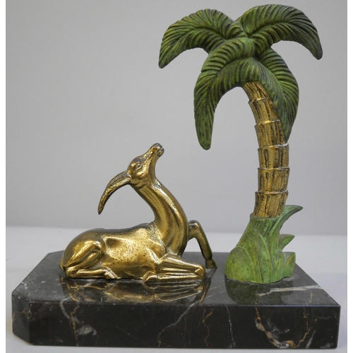 639 - A 1940's bookend featuring a gazelle figure and a Palm tree mounted on a polished marble base