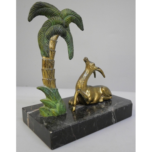 639 - A 1940's bookend featuring a gazelle figure and a Palm tree mounted on a polished marble base