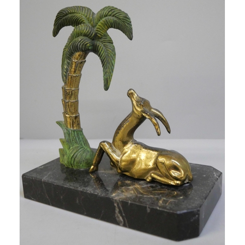 639 - A 1940's bookend featuring a gazelle figure and a Palm tree mounted on a polished marble base