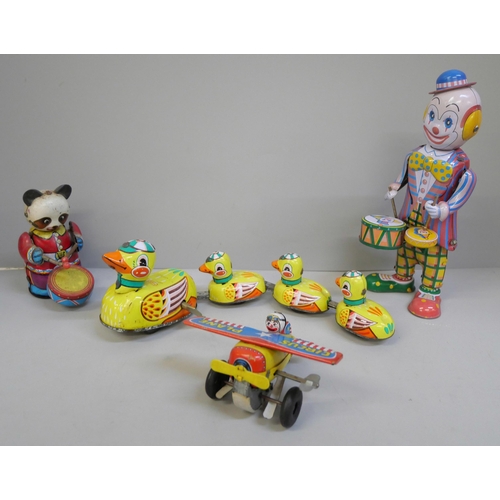 641 - Tin plate toys; clockwork clown, plane, drumming Panda and clockwork ducks