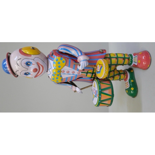 641 - Tin plate toys; clockwork clown, plane, drumming Panda and clockwork ducks