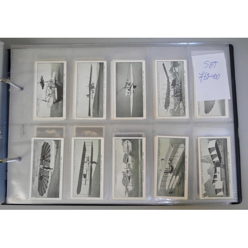 647 - An album with 14 sets of cigarette cards