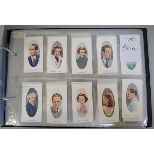 647 - An album with 14 sets of cigarette cards