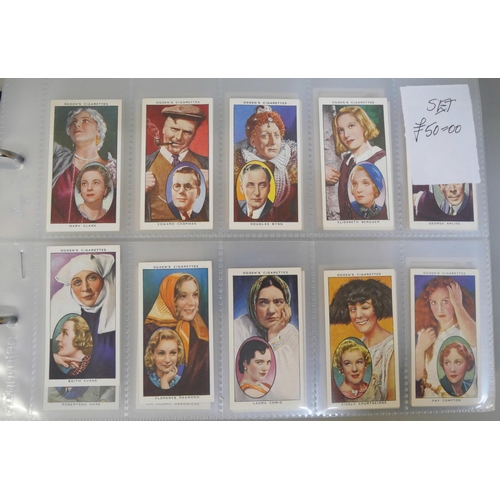 647 - An album with 14 sets of cigarette cards