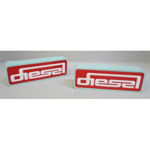 656 - A pair of Diesel (clothing) painted wooden shop display signs