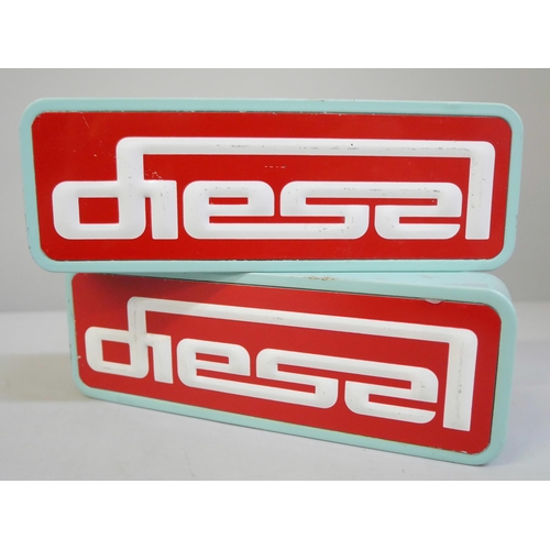 656 - A pair of Diesel (clothing) painted wooden shop display signs