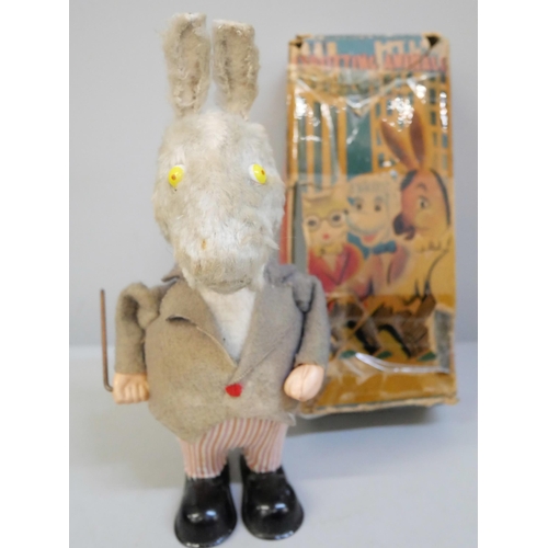 657 - A Strutting Animals clockwork donkey with twirling cane and moving ears, boxed, a tin plate motorcyc... 