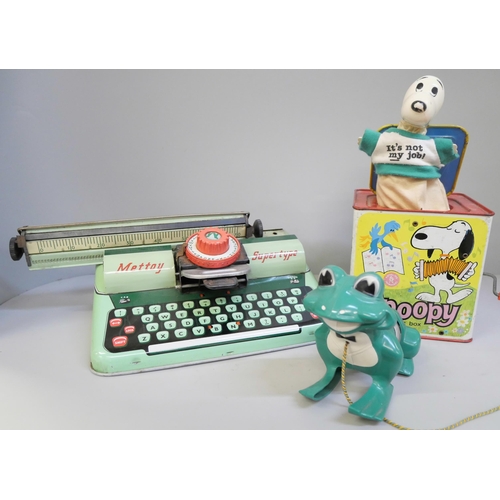 659 - A Mettoy Supertype tinplate typewriter, Snoopy Peanuts Jack in the Box and a Mr Wiggles Leap Frog