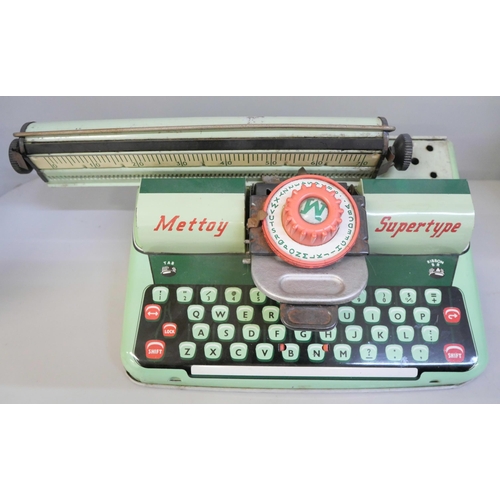 659 - A Mettoy Supertype tinplate typewriter, Snoopy Peanuts Jack in the Box and a Mr Wiggles Leap Frog