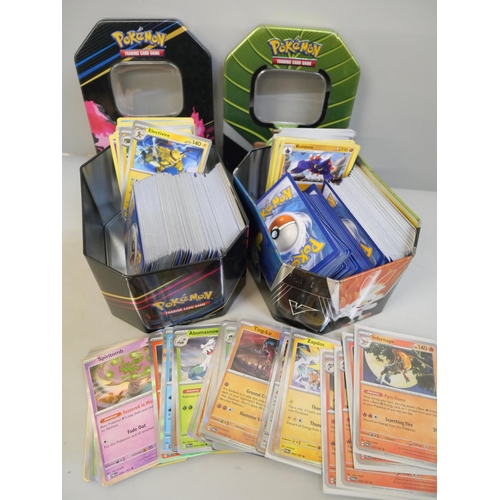 689 - A large quantity of Pokemon cards in two collectors tins with black Star rare Holographic, cards are... 