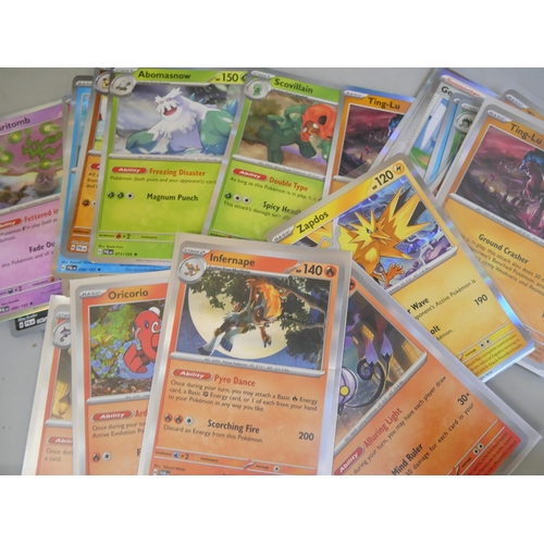 689 - A large quantity of Pokemon cards in two collectors tins with black Star rare Holographic, cards are... 