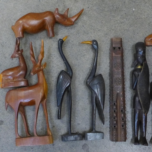 740 - A collection of carved wooden tourist items including four deer, rhino, two figures, three birds