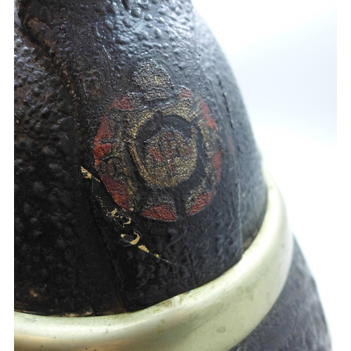 742 - A fireman's helmet, circa 1920s, stamped made in Glasgow, JAS Hendry