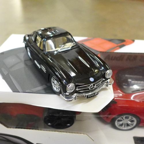 744 - A radio controlled 1:14 scale Audi R8, a 2003 Lincoln Limousine model, and a Burago Mercedes-Benz