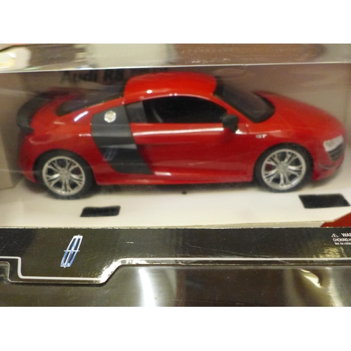 744 - A radio controlled 1:14 scale Audi R8, a 2003 Lincoln Limousine model, and a Burago Mercedes-Benz