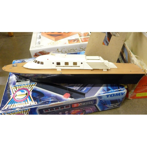 782 - A Tomy Atomic pinball, boxed, a Vosper Triple screw Express Turbine yacht, a Bee Vision Transformer ... 