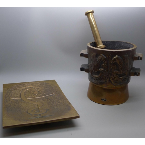 791 - A heavy bronze pestle and mortar and a bronze tray with anchor decoration