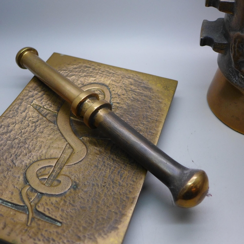 791 - A heavy bronze pestle and mortar and a bronze tray with anchor decoration