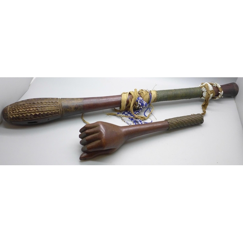 815 - An African tribal club and a carved club or walking cane top in the form a clenched hand