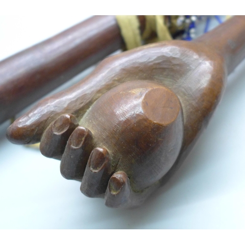 815 - An African tribal club and a carved club or walking cane top in the form a clenched hand