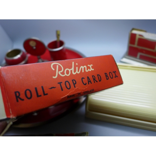 825 - A 1930s Bridge card set and tray and Rolinx roll-top card box with two packs of playing cards, seale... 