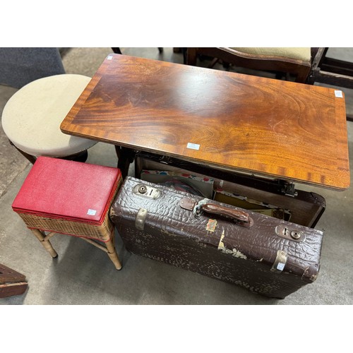 255 - A mahogany coffee table, a wicker sewing box, a beech stool and a leather suitcase