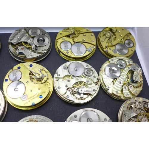 913 - A collection of pocket watch movements and dials, including Waltham, J.W Benson, Elgin, etc.