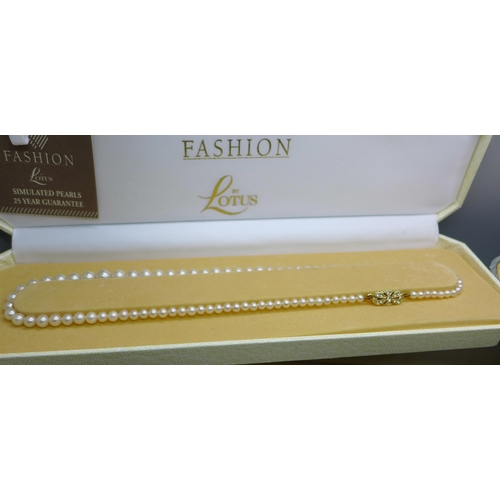 918 - A collection of faux pearls, one string with silver clasp