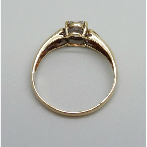 932 - A 9ct gold ring set with a white central stone and small diamonds, 2.7g, W