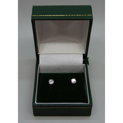 952 - A pair of hallmarked 18ct white gold diamond stud earrings, total diamond cut 0.54, 1g