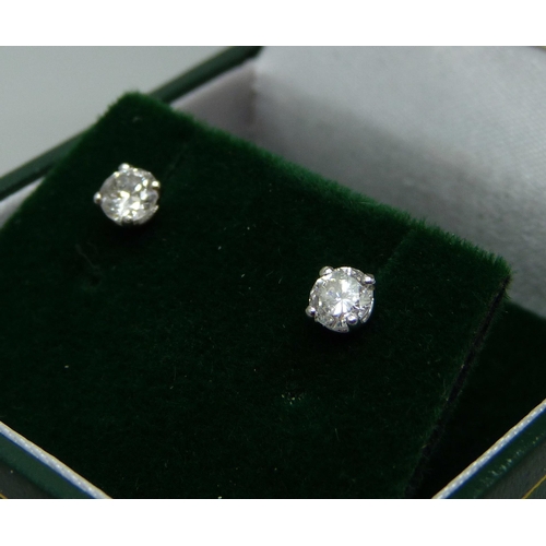 952 - A pair of hallmarked 18ct white gold diamond stud earrings, total diamond cut 0.54, 1g