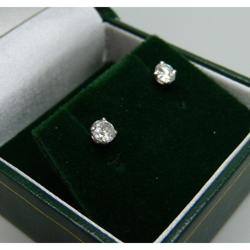 952 - A pair of hallmarked 18ct white gold diamond stud earrings, total diamond cut 0.54, 1g