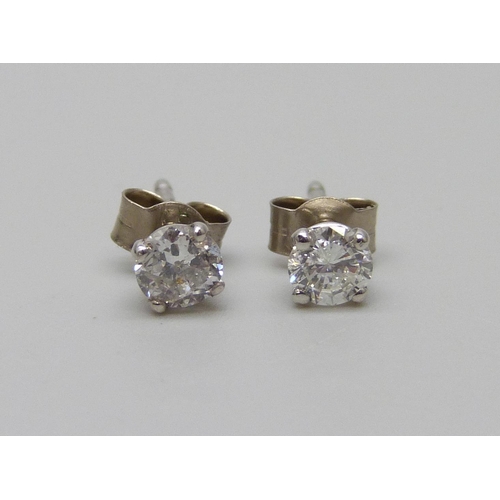 952 - A pair of hallmarked 18ct white gold diamond stud earrings, total diamond cut 0.54, 1g