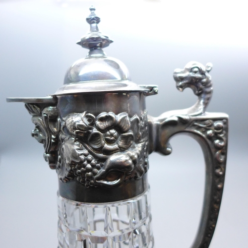 962 - A silver topped claret jug with embossed design, Sheffield 1985, 30cm