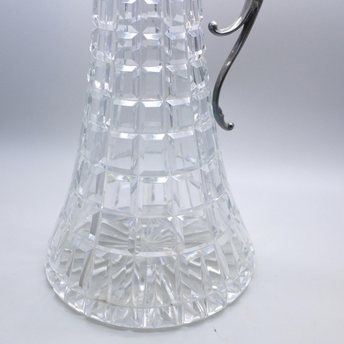 962 - A silver topped claret jug with embossed design, Sheffield 1985, 30cm