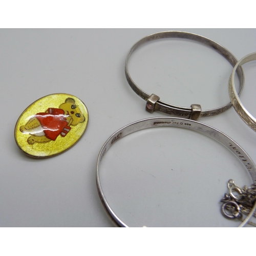 973 - A collection of child's size silver bangles, an enamelled brooch and five silver lockets, 41g