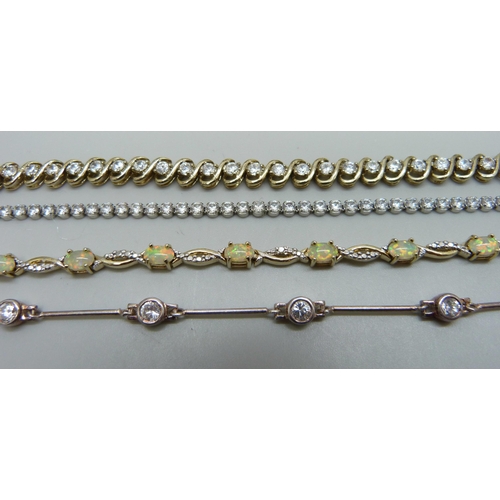 974 - Four silver and gilt stone set bracelets, 32g