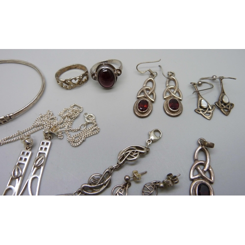 975 - A collection of Celtic style silver jewellery including a bangle and two bracelets, 63g