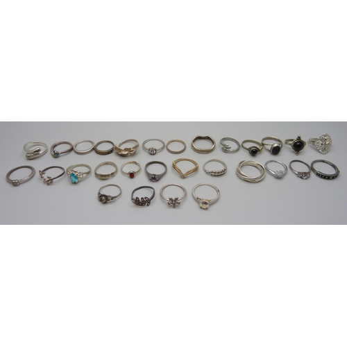 981 - Twenty two silver rings, 48g, together with seven white metal and plated rings