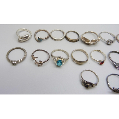 981 - Twenty two silver rings, 48g, together with seven white metal and plated rings