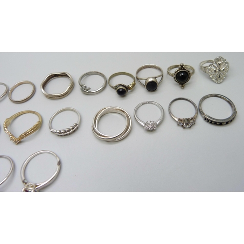 981 - Twenty two silver rings, 48g, together with seven white metal and plated rings